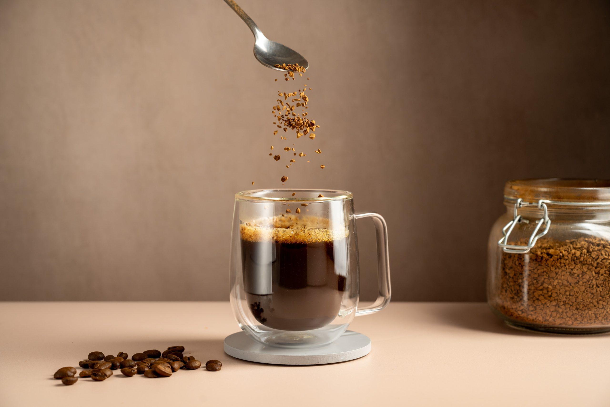 Spoon Pouring Liquid into Glass Cup – Indoor Beverage Serving Scene